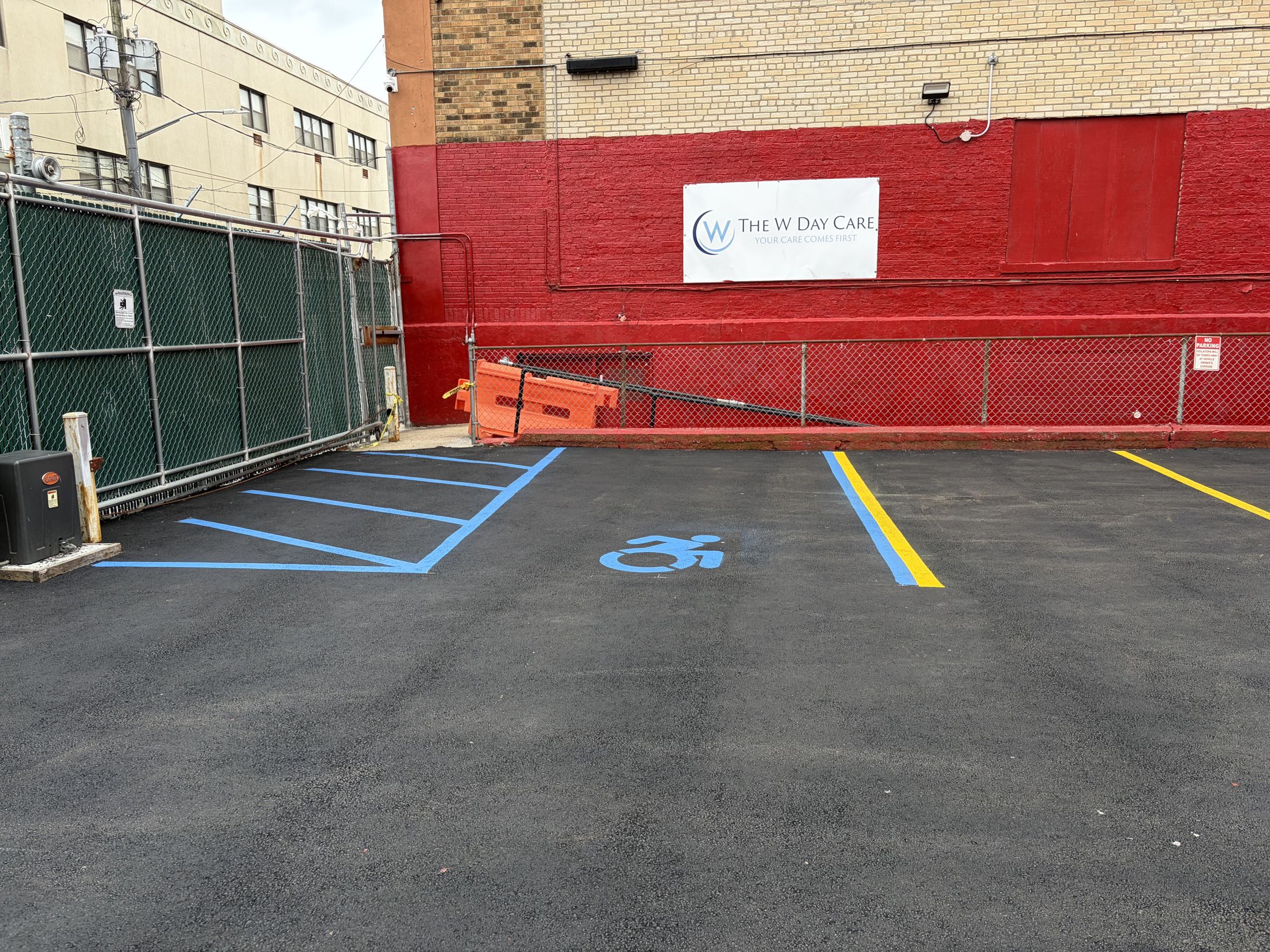 Newly paved and restriped parking lot with an accessible space in Belle Harbor, New York