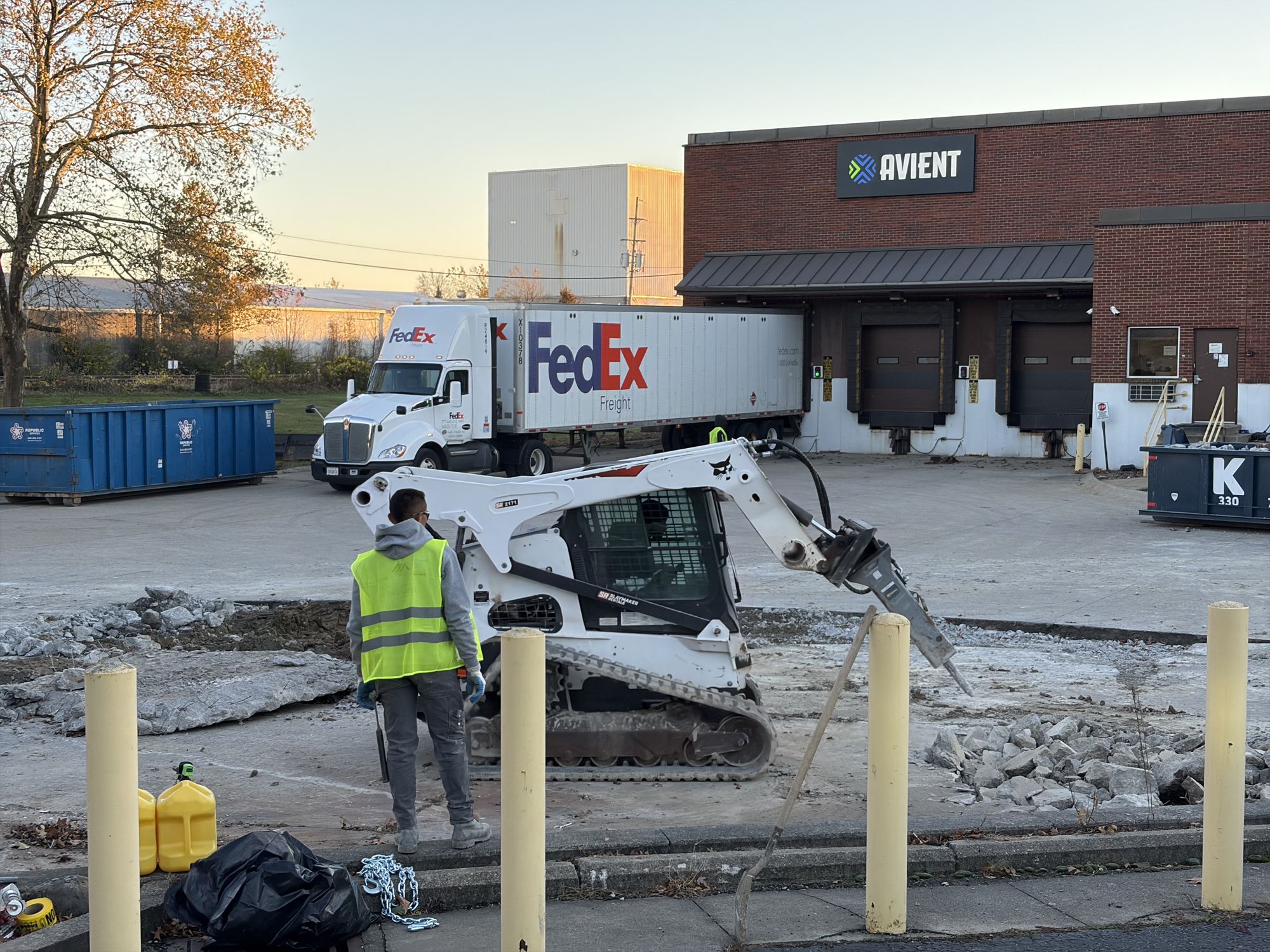 Skid steer breaking out an old concrete apron at a loading dock in Berea, Ohio